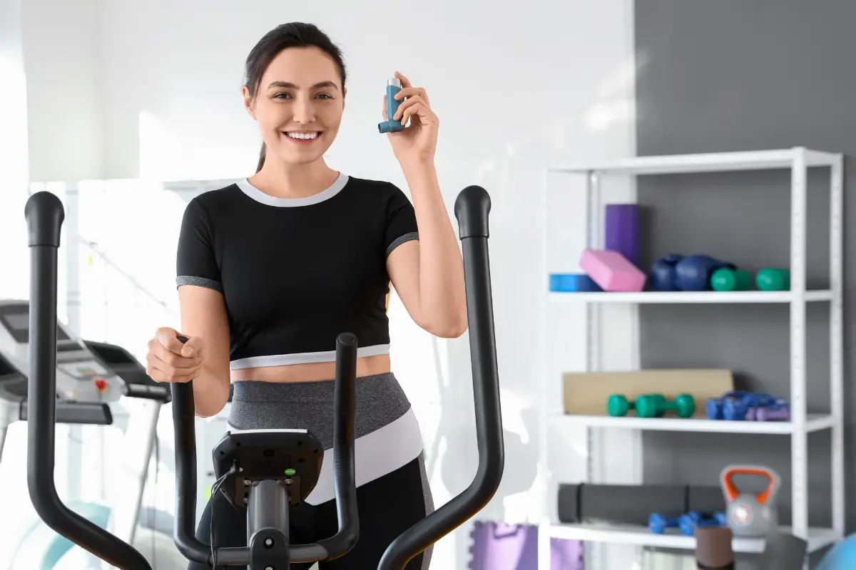 Woman on elliptical trainer holding a asthma inhaler in McKinney, TX